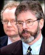Sinn Fein president Gerry Adams and Martin McGuinness behind