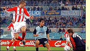 Red Star Belgrade goalkeeper Ivan Randjelovic gathers the ball ahead of Lazio's Simone Inzaghi