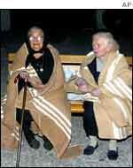 Elderly women wrapped in blankets