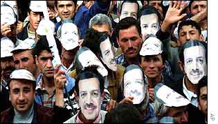 Supporters of AK party ware Erdogan masks at an election rally