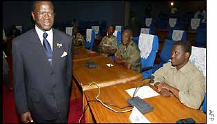 Govt negotiator Laurent Dona Fologo walks past the rebel forces delegation