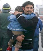 An man takes his daughter to safety after an aftershock