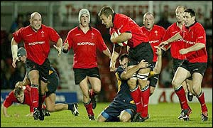 Gareth Llewellyn is smothered by a Romanian tackle as the Welsh forwards attack