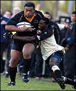 London Irish wing Paul Sackey tries to halt Newcastle's Epi Taione