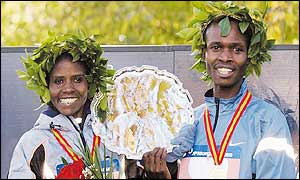 Joyce Chepchumba and Rodgers Rop pose with their trophies after winning in New York 