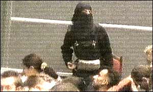 A terrorist strapped with explosives mingles with the audience