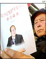 A Chinese man reads a book about an important speech by Chinese President Jiang Zemin