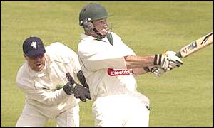 Graeme Hick pulls the ball for four