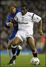 Jay-Jay Okocha being marked by Birmingham's Robbie Savage 