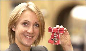 Paula Radcliffe poses with her MBE outside Buckingham Palace