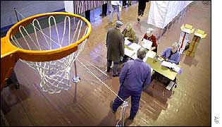 Voters cast their votes in basketball court doubling as a makeshift polling station 