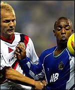 Wigan striker Nathan Ellington fends off the attention of Manchester City defender Gerard Wiekens