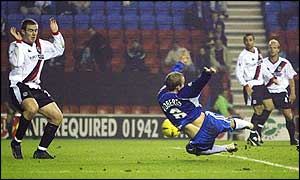 Wigan's Neil Roberts scores the winner against Manchester City