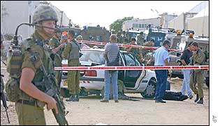 Soldiers and police at the scene of the settler shootings