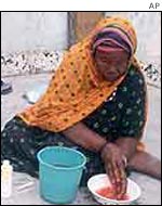 A woman washes her hands after circumcising a Somali girl