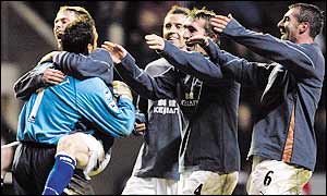Everton keeper Richard Wright is mobbed by his team-mates after twice pulling off saves in the penalty shoot-out 