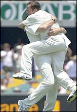Ashley Giles and Craig White celebrate the wicket of Adam Gilchrist