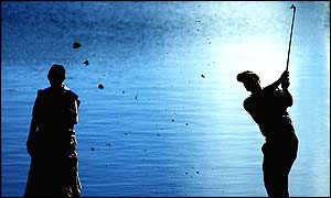 Padraig Harrington in silhouette as he plays a shot by the lake at Valderrama