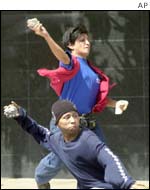 Supporters of President Hugo Chavez throw stones at opponents in Caracas, 4 November, 2002