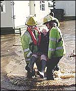 firefighters rescuing trapped resident