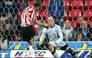 James Beattie of Southampton scores from a penalty against Blackburn Rovers goalie Brad Friedel,