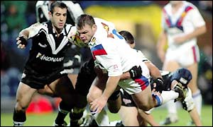 Keiron Cunningham runs into a wall of New Zealand defenders