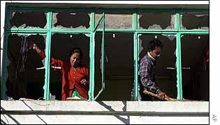 Woman cleans up after bomb attack on Royal Nepal Airlines HQ in Kathmandu