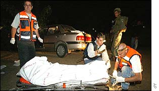 Rescue workers with the body of a victim of the gunman