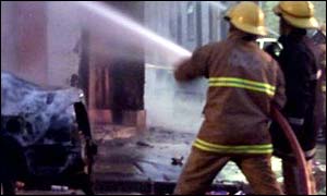 Two firefighters tackle a blaze