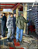 Lebanese police inspect damage at Winners restaurant outside Jounieh