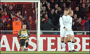 Sami Hyypia (right), and Steven Gerrard (centre) walk away after keeper Dudek picks the ball from his net