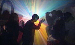 Teenagers dancing at a rave