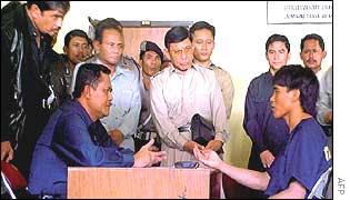 Bachtiar (L) talks to terror suspect Amrozi (R) at Denpasar Police headquarters, Bali 