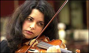 A violinist plays the sale's Stradivarius violin 