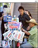 Young people at a newspaper stand