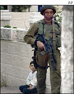 Israeli soldier and Palestinian boy