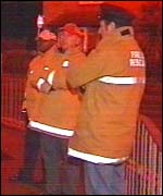 Firemen look on