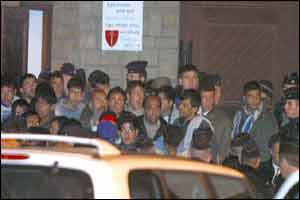Evacuated asylum-seekers outside the church