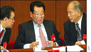 Parliament Chairman Li Peng (L) chats with top adviser Li Ruihuan (C) and politburo member Wei Jianxing