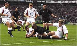 Lomu scores, despite the attention of Jason Robinson and Mike Tindall