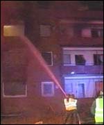 Military personnel tackle a fire