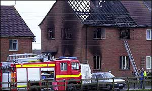 A retained fire engine attends a house fire