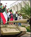 Jubilant Kuwaitis aboard a US tank