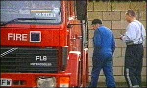 Retained firefighters inspect the damage
