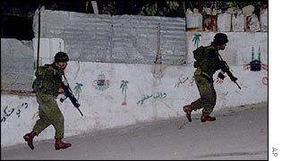 Israeli soldiers secure an area