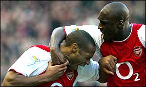 Thierry Henry is mobbed by Sol Campbell after his fantastic goal 