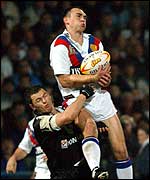 Kevin Sinfield catches the ball under pressure from Robbie Paul