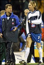 Birmingham's Robbie Savage limps off after the match against Fulham, holding an ice pack to his groin strain