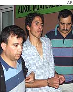 Alleged hijacker is led away in handcuffs for questioning