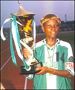 Florence Omagbemi holding the African Women's Championship trophy